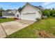 A home with a well-maintained lawn, blooming flowers, and an attached two-car garage at 402 Lafayette St, Dallas, GA 30157