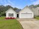 Charming single-story home with a well-maintained lawn and a two-car garage at 402 Lafayette St, Dallas, GA 30157