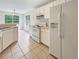 Bright kitchen featuring white cabinetry, modern appliances, and tiled flooring for a clean, classic look at 402 Lafayette St, Dallas, GA 30157