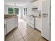 Bright kitchen featuring white cabinets, matching appliances, and windows overlooking the backyard at 402 Lafayette St, Dallas, GA 30157