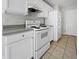 Functional kitchen with ample white cabinetry, appliances, and tile flooring for easy maintenance at 402 Lafayette St, Dallas, GA 30157
