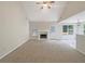 Spacious living room with a fireplace, vaulted ceiling, and view to the dining area at 402 Lafayette St, Dallas, GA 30157