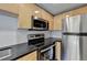 Modern kitchen with stainless steel appliances and light wood cabinets at 385 Ralph Mcgill Ne Blvd # Q, Atlanta, GA 30312