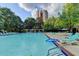 Community pool with plenty of lounge chairs and umbrellas at 385 Ralph Mcgill Ne Blvd # Q, Atlanta, GA 30312