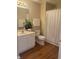 Bathroom with laminate flooring, vanity with sink, toilet and tub shower at 6133 Malloway Ct, Cumming, GA 30041