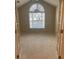 A bedroom with vaulted ceilings and a large arched window providing natural light at 6133 Malloway Ct, Cumming, GA 30041