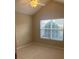 Bright bedroom with a vaulted ceiling, neutral carpet, and a large window at 6133 Malloway Ct, Cumming, GA 30041