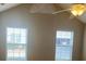 Bedroom featuring a high ceiling with a ceiling fan and a large arched window at 6133 Malloway Ct, Cumming, GA 30041