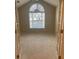 Bedroom with a large arched window allowing natural light and door leading into the room at 6133 Malloway Ct, Cumming, GA 30041