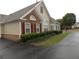 Inviting single story home showcasing red shutters, a brick facade, and manicured landscaping at 6133 Malloway Ct, Cumming, GA 30041