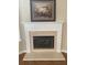 Close up of a fireplace with white mantle, tile surround, and glass doors offering a warm focal point at 6133 Malloway Ct, Cumming, GA 30041