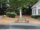 Front yard with a bench under a tree and landscaping elements near the home at 6133 Malloway Ct, Cumming, GA 30041