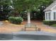 Cozy front yard with bench shaded by a tree and landscaped surroundings at 6133 Malloway Ct, Cumming, GA 30041