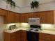 Kitchen featuring wooden cabinets, modern white appliances, under cabinet lighting, and neutral countertops at 6133 Malloway Ct, Cumming, GA 30041