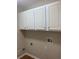 Laundry room with overhead cabinets and a washer and dryer hook up at 6133 Malloway Ct, Cumming, GA 30041