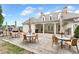 Community clubhouse patio area with tables, chairs, and umbrellas for outdoor dining and relaxation at 6133 Malloway Ct, Cumming, GA 30041