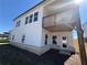 Back of home showing a second story deck and walk out basement with a small patio at 64 Dew Lake Ct, Grayson, GA 30017