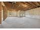 Unfinished basement featuring exposed wood beams and newly installed foam insulation at 64 Dew Lake Ct, Grayson, GA 30017