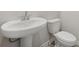 Clean half bathroom displays a pedestal sink and elongated toilet that maximizes the small space at 64 Dew Lake Ct, Grayson, GA 30017