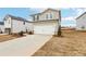 View of the home's front, showcasing the two-car garage, driveway, and landscaping at 64 Dew Lake Ct, Grayson, GA 30017