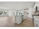 View of open kitchen with stainless appliances, center island, and light-filled windows at 64 Dew Lake Ct, Grayson, GA 30017