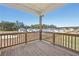 A look at the wooden deck on the second story with a view of neighboring homes at 64 Dew Lake Ct, Grayson, GA 30017