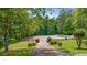 Gated horse arena surrounded by mature trees and lush landscaping, ready for equestrian activities at 2585 Gelding Ne Ct, Marietta, GA 30062