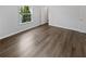 Clean, empty bedroom with hardwood floors and a large window for natural light at 806 Brighton Pt, Atlanta, GA 30328