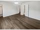 Bright bedroom featuring new vinyl wood floors, white walls, and a walk-in shower in the en-suite at 806 Brighton Pt, Atlanta, GA 30328