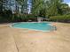 A large community pool on a sunny day is surrounded by plenty of trees, bushes, and space at 806 Brighton Pt, Atlanta, GA 30328