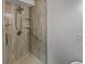 Clean, updated shower stall with textured walls, shelving, and accessible hand rails at 806 Brighton Pt, Atlanta, GA 30328