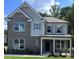 Beautiful two-story home featuring a brick facade, gray siding, covered porch, and manicured front lawn at 558 Abbott Se Ct, Atlanta, GA 30354