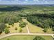 A captivating aerial view showcases a sprawling property embraced by lush greenery under a partly cloudy sky at 500 Cochran Rd, Covington, GA 30014