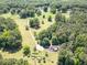 Breathtaking aerial shot of a serene property featuring a tree-lined driveway, pond, and house at 500 Cochran Rd, Covington, GA 30014