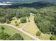 A serene aerial view captures a property surrounded by verdant trees, featuring a long driveway at 500 Cochran Rd, Covington, GA 30014