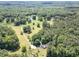 Beautiful aerial view showcases the extensive green landscape, peaceful pond, and cozy home of this property at 500 Cochran Rd, Covington, GA 30014