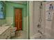 A bright bathroom with a stained glass window above the toilet, a stall shower, and a green paint scheme at 500 Cochran Rd, Covington, GA 30014