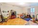 A bedroom with hardwood floors, a queen-sized bed, a dresser, and a side table with a window at 500 Cochran Rd, Covington, GA 30014