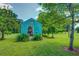 Exterior view of the backyard with storage shed, well-maintained yard, and lush greenery at 500 Cochran Rd, Covington, GA 30014