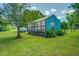 Exterior view of a turquoise shed on a lush green lawn surrounded by a beautiful green yard at 500 Cochran Rd, Covington, GA 30014