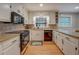 Bright kitchen with white cabinets, stone backsplash, granite countertops, and modern appliances at 500 Cochran Rd, Covington, GA 30014