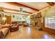 Cozy living room with stone fireplace, wood-beam ceiling and comfortable furniture at 500 Cochran Rd, Covington, GA 30014