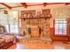 Bright living room features a stone fireplace and large windows at 500 Cochran Rd, Covington, GA 30014