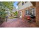 View of the backyard with brick, a window, and a seating area with a barbecue grill at 6 Dover Trl, Peachtree City, GA 30269