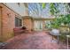 Spacious backyard patio with a grill, bench, surrounded by foliage and a lush green space at 6 Dover Trl, Peachtree City, GA 30269