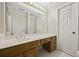 Bright bathroom featuring a vanity with drawers, sink, and large mirror with decorative lighting at 6 Dover Trl, Peachtree City, GA 30269