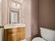 Powder room features a vanity, mirror, and toilet at 6 Dover Trl, Peachtree City, GA 30269