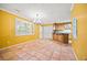 Open dining area with tile floors, chandelier, and an adjacent kitchen at 6 Dover Trl, Peachtree City, GA 30269