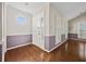 Bright entryway showcasing hardwood floors, wainscotting, and a unique octagon window at 6 Dover Trl, Peachtree City, GA 30269