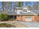 Charming home featuring a brick facade, attached garage, and meticulously landscaped front yard at 6 Dover Trl, Peachtree City, GA 30269